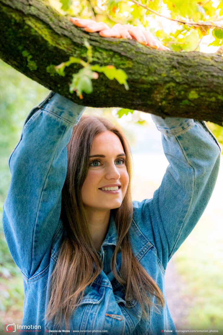 Model Nicole Smiling Hands On Tree